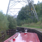 UK: Huddersfield Narrow Canal, passing under a pylon near Staleybridge [Picture by Howard Fisher]